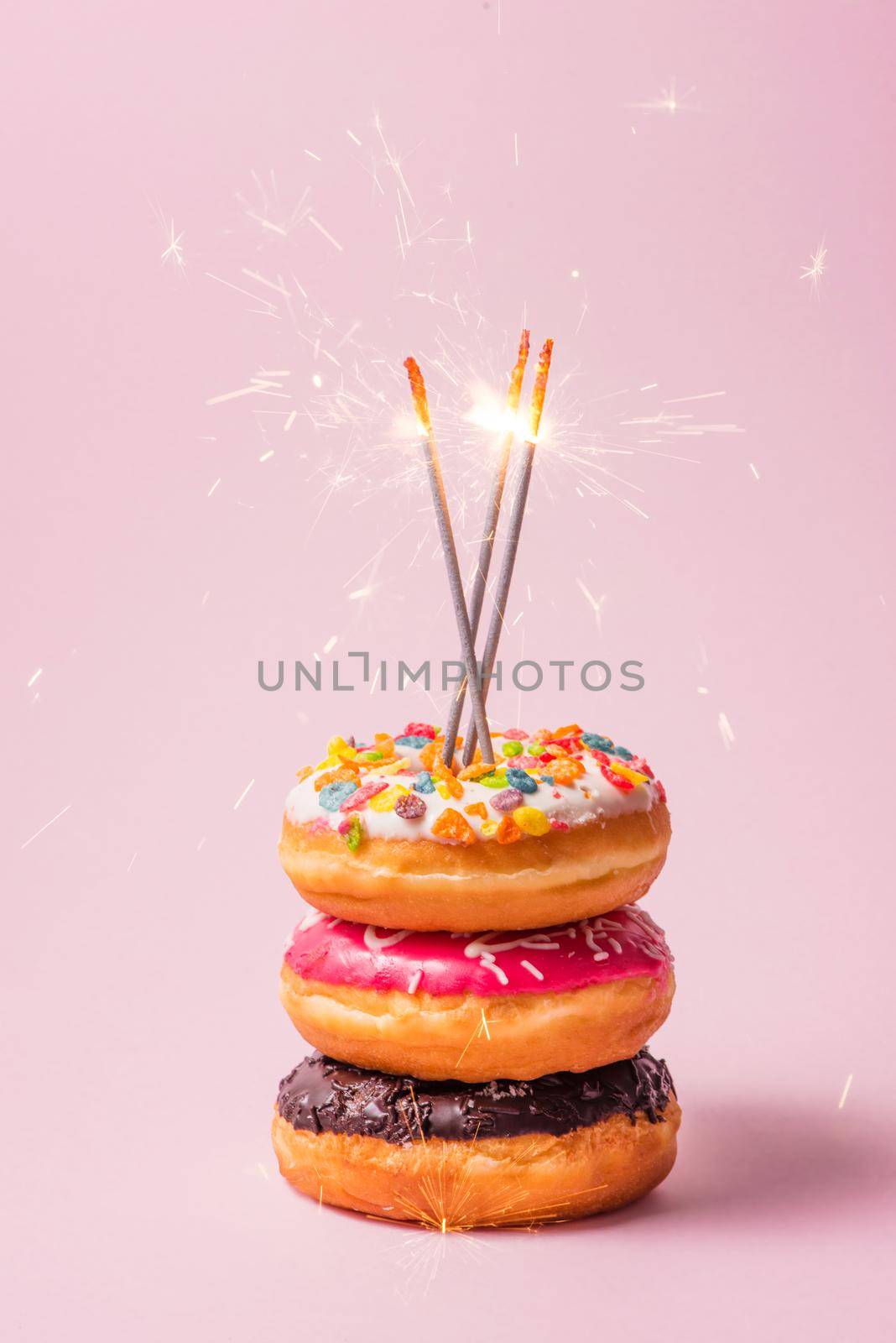Delicious donuts for birthday on pastel pink background. by makidotvn