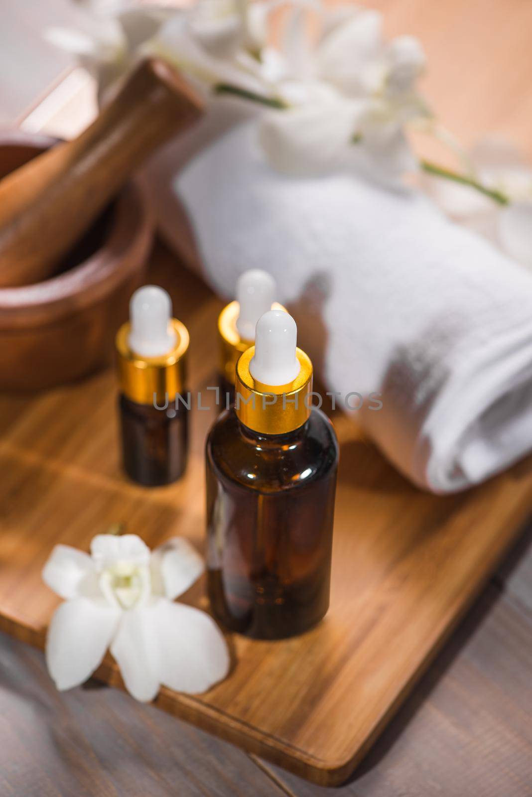 Spa still life with towel, white orchid, bath oil by makidotvn