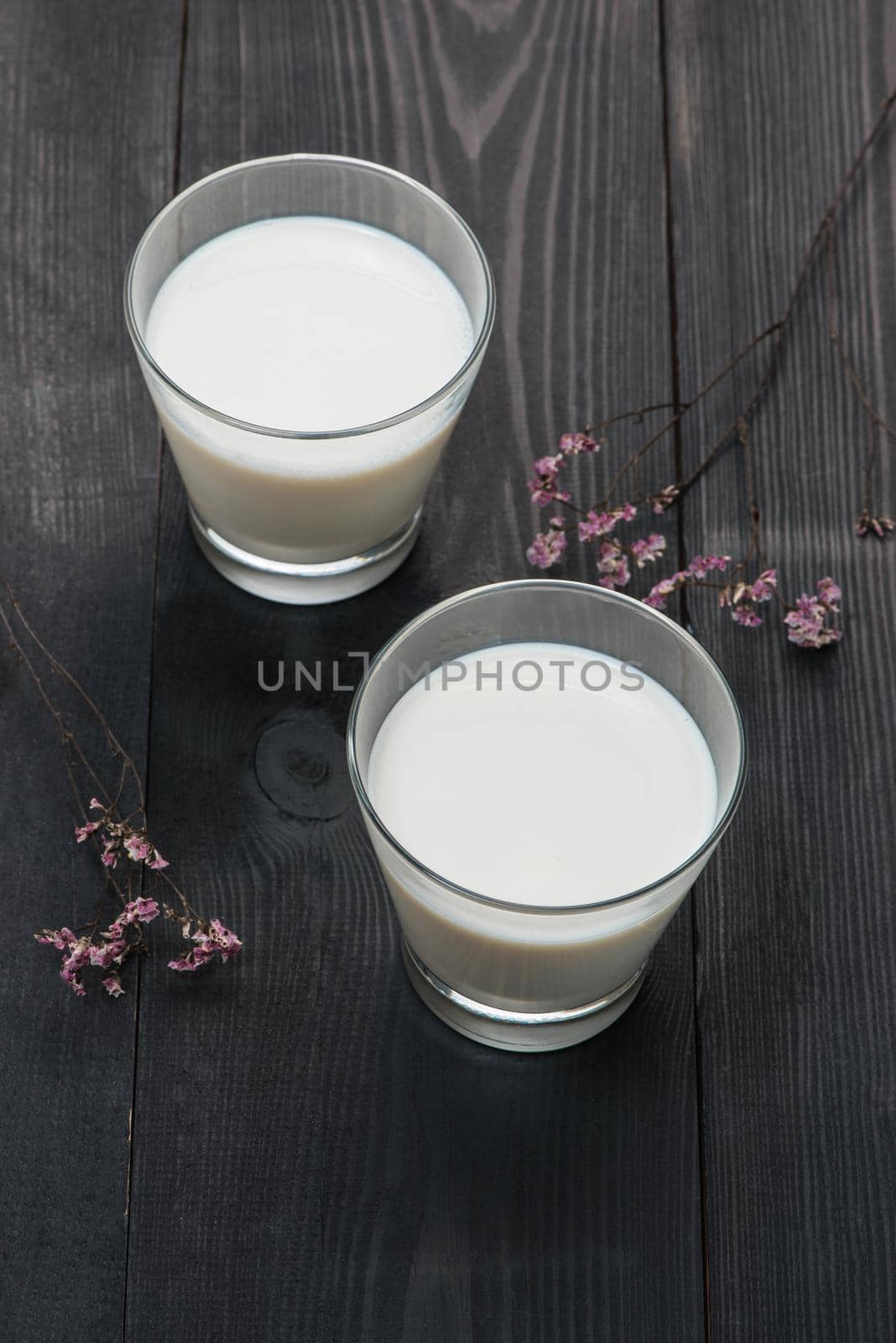 Dairy products. Two glasses of milk on a rustic wooden table. by makidotvn