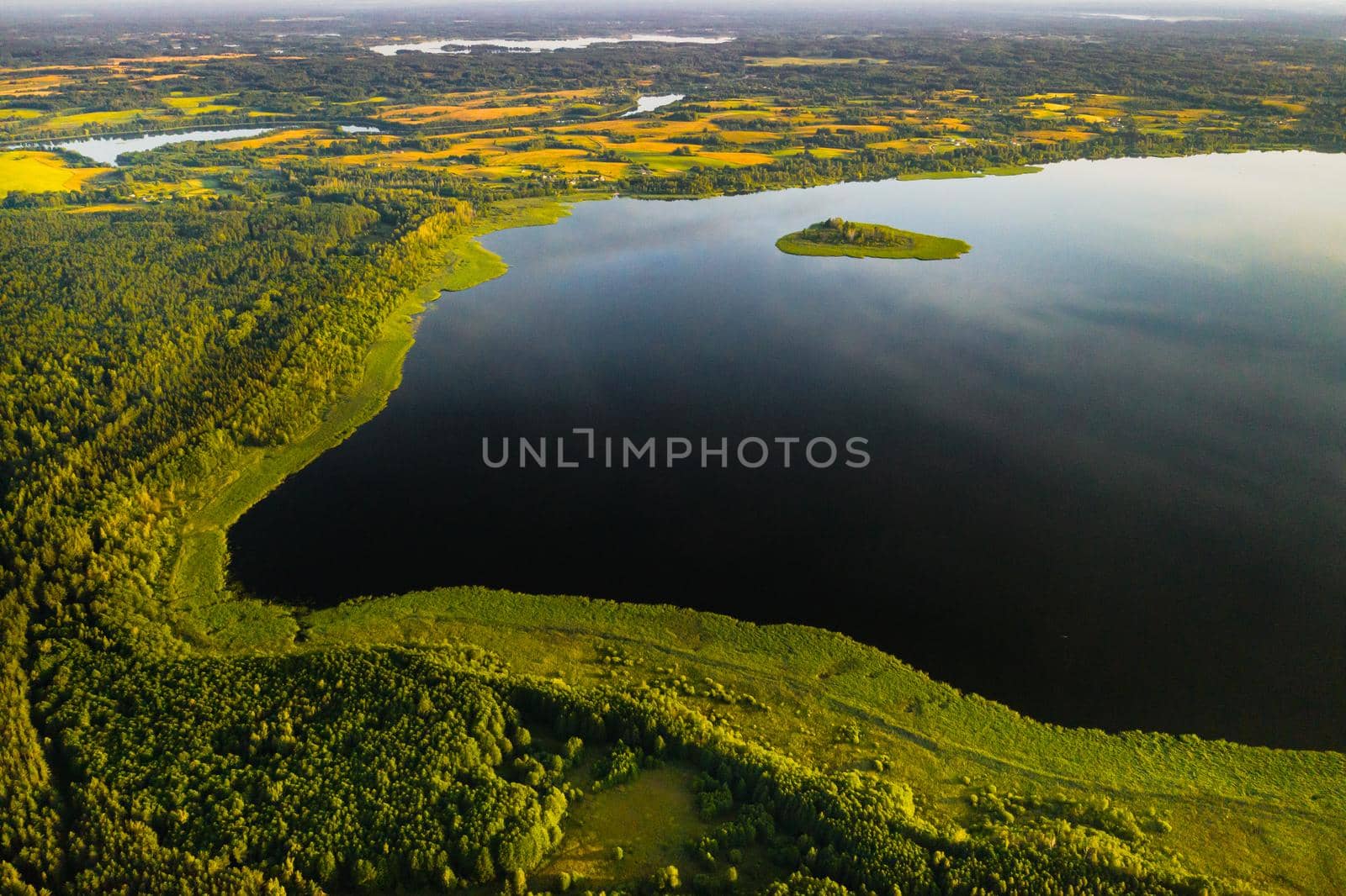 Top view of lake Drivyaty in the forest in the Braslav lakes National Park at sunset, the most beautiful places in the city of Belarus.An island in the lake.Belarus