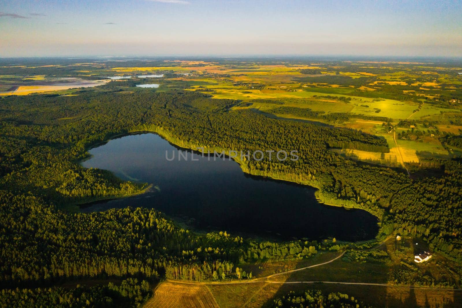 Top view of Bolta lake in the forest in the Braslav lakes National Park at dawn, the most beautiful places in Belarus.An island in the lake.Belarus