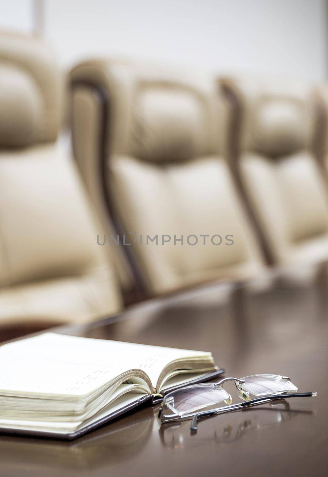 Closeup of on table in empty corporate conference room before business meeting in office