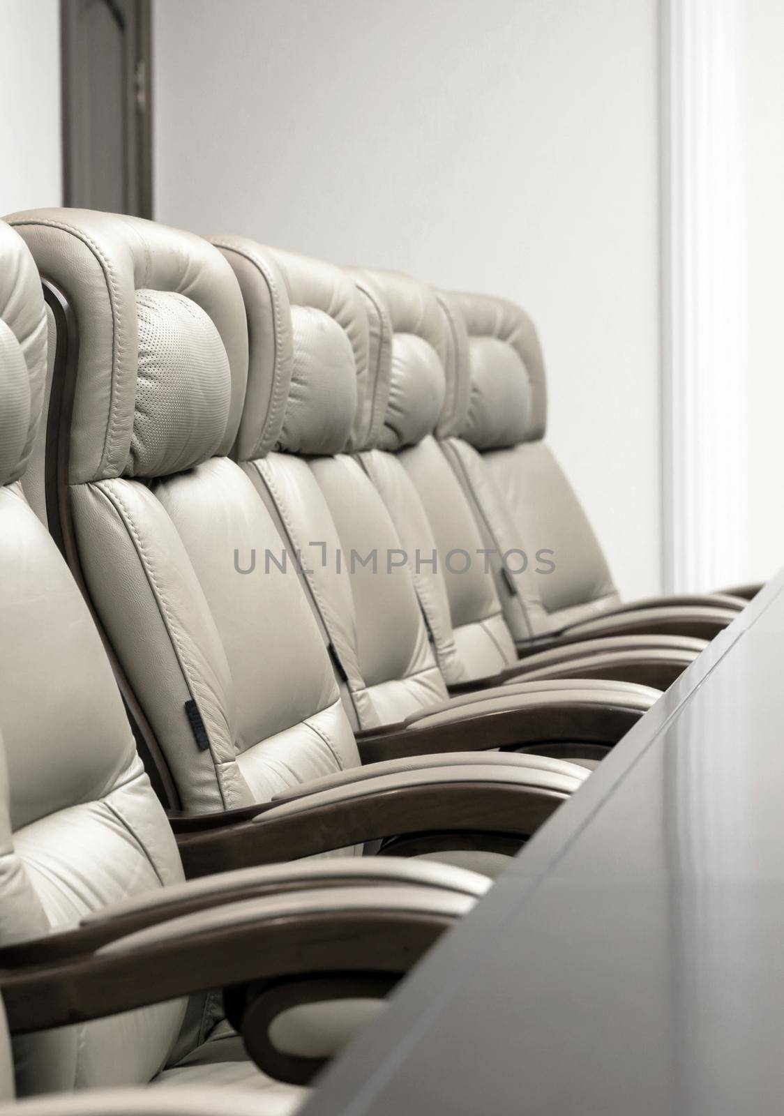 conference room with wooden table and beige leather armchairs