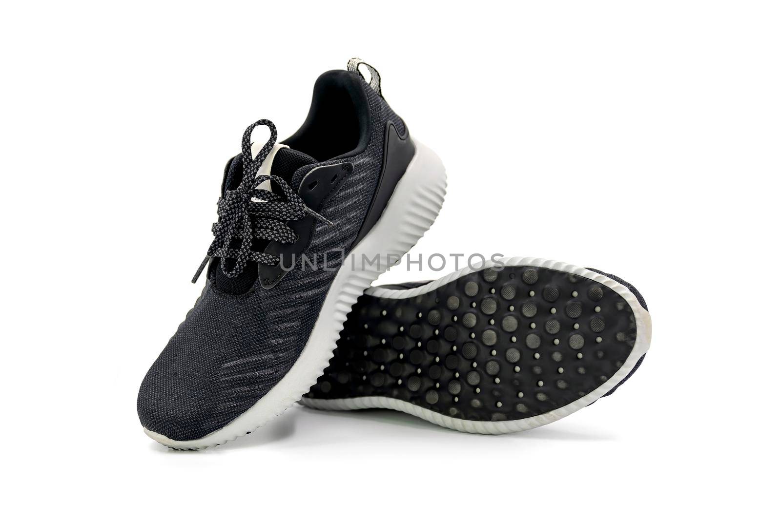 Pair of black color fashion sport shoes isolated on white background. by wattanaphob
