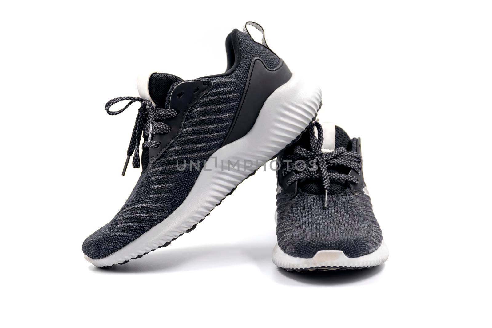 Pair of black color fashion sport shoes isolated on white background.