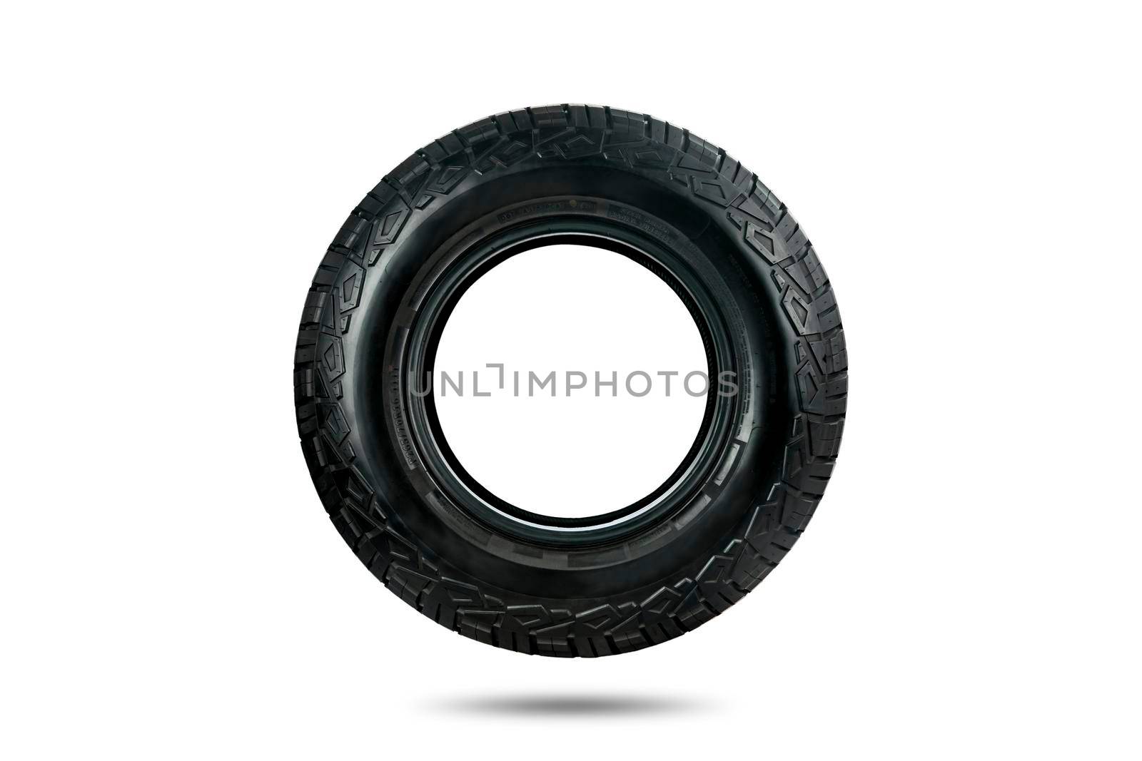 Side view of an all terrain tire designed for use in all road conditions isolated on white background.