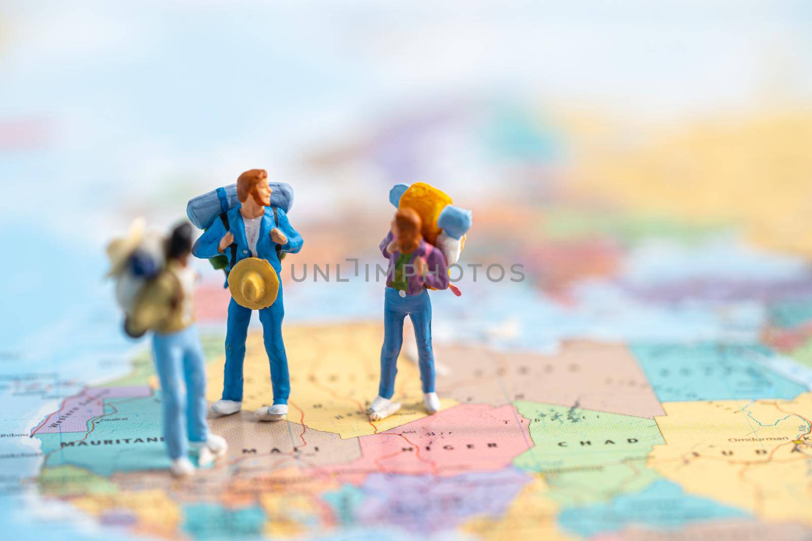 Miniature people, Two backpacker enjoy to discovery journey travel at amazing on world map. by pamai