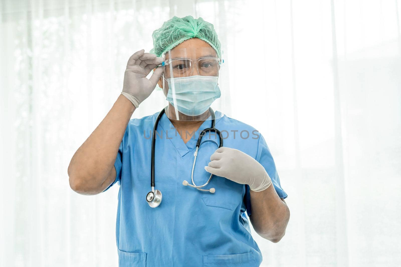 Asian doctor wearing mask, face shield and PPE suit new normal isolated on white background with clipping path to protect safety infection Covid-19 Coronavirus. by pamai