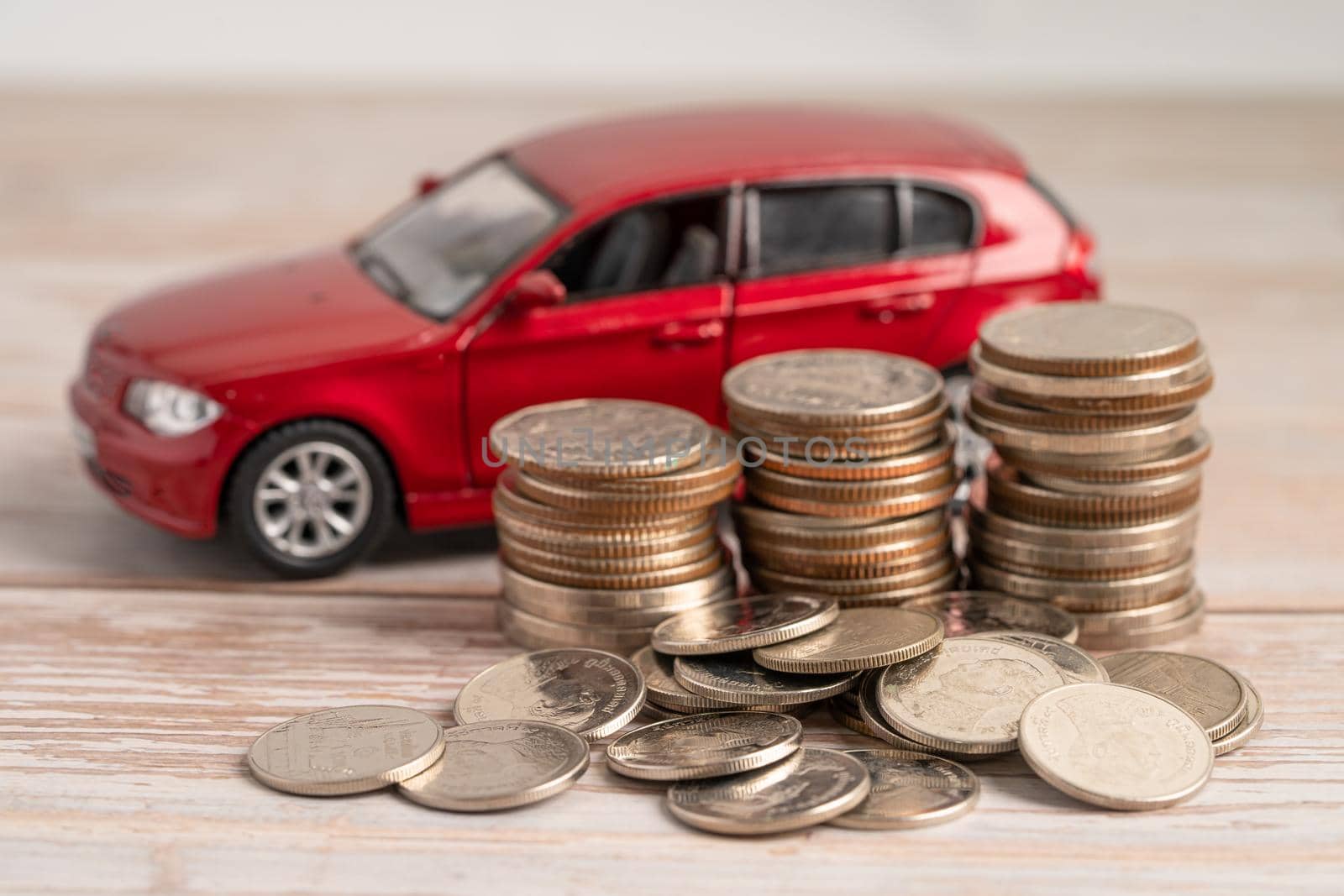 Car on coins background; Car loan, Finance, saving money, insurance and leasing time concepts. by pamai