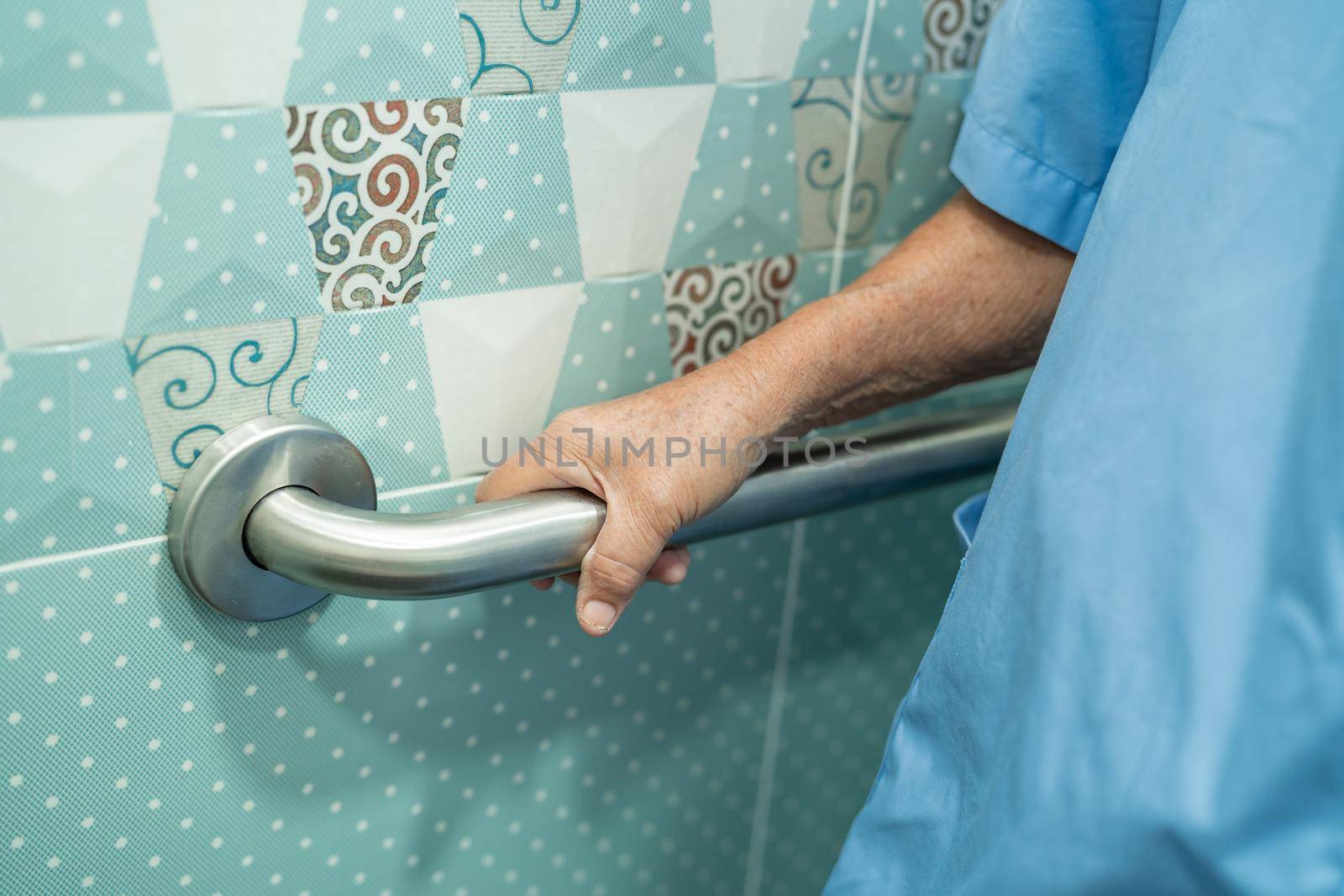 Asian senior or elderly old lady woman patient use slope walkway handle security with help support assistant in nursing hospital ward; healthy strong medical concept.