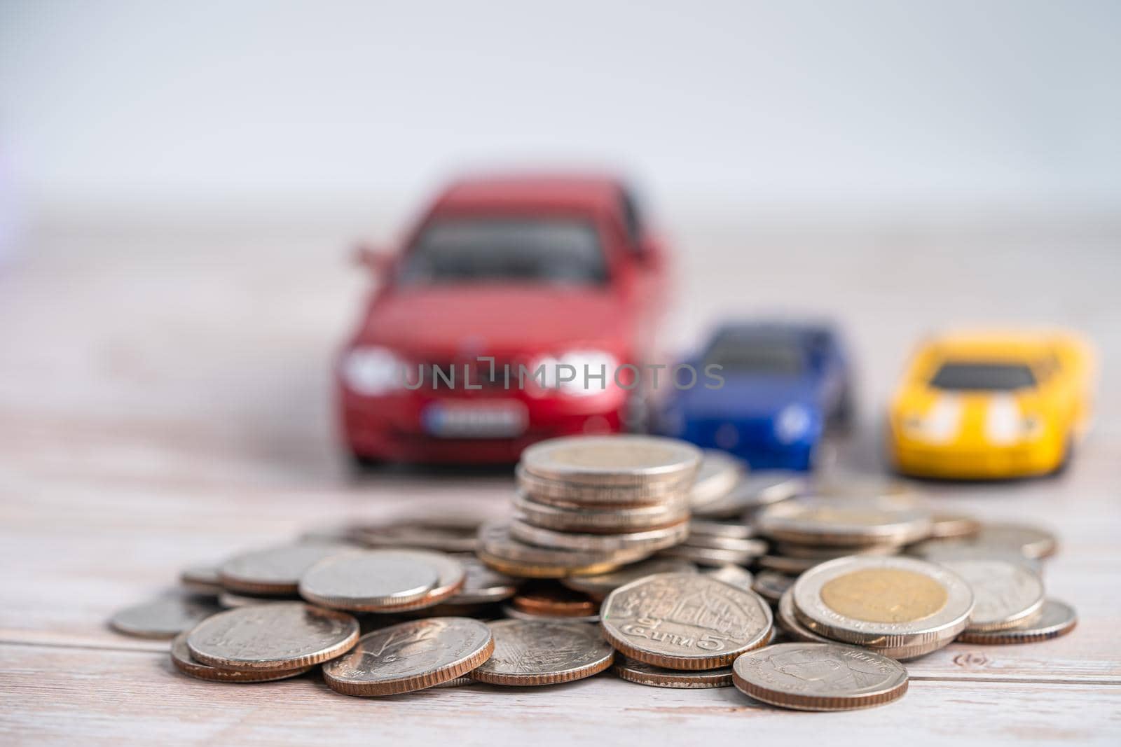 Car on coins background; Car loan, Finance, saving money, insurance and leasing time concepts.