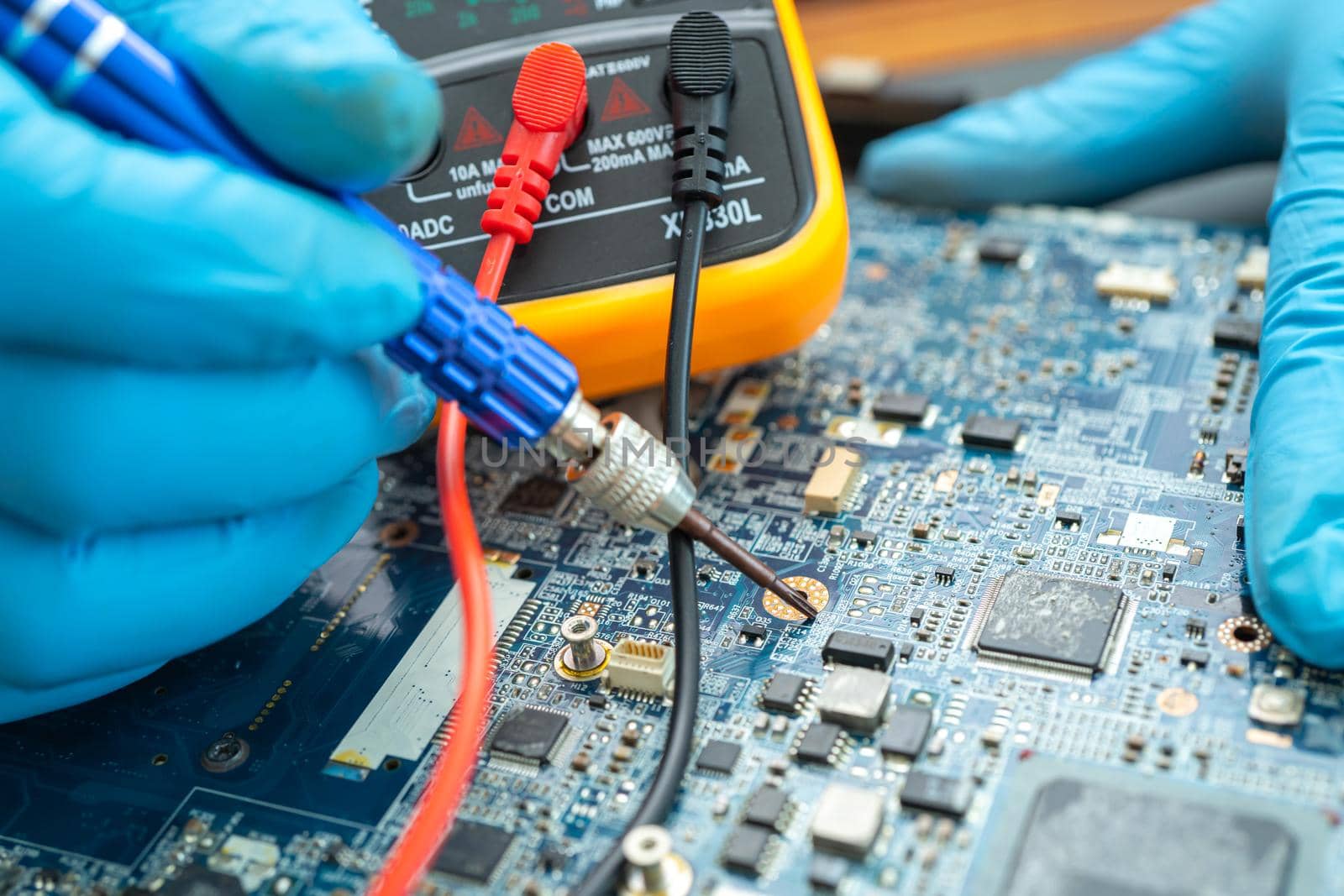 technician repairing inside of hard disk by soldering iron. Integrated Circuit. the concept of data, hardware, technician and technology.