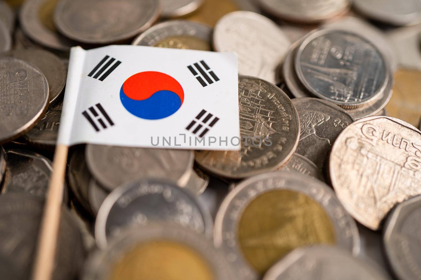 Stack of coins with Korea flag on white background. flag on white background. by pamai
