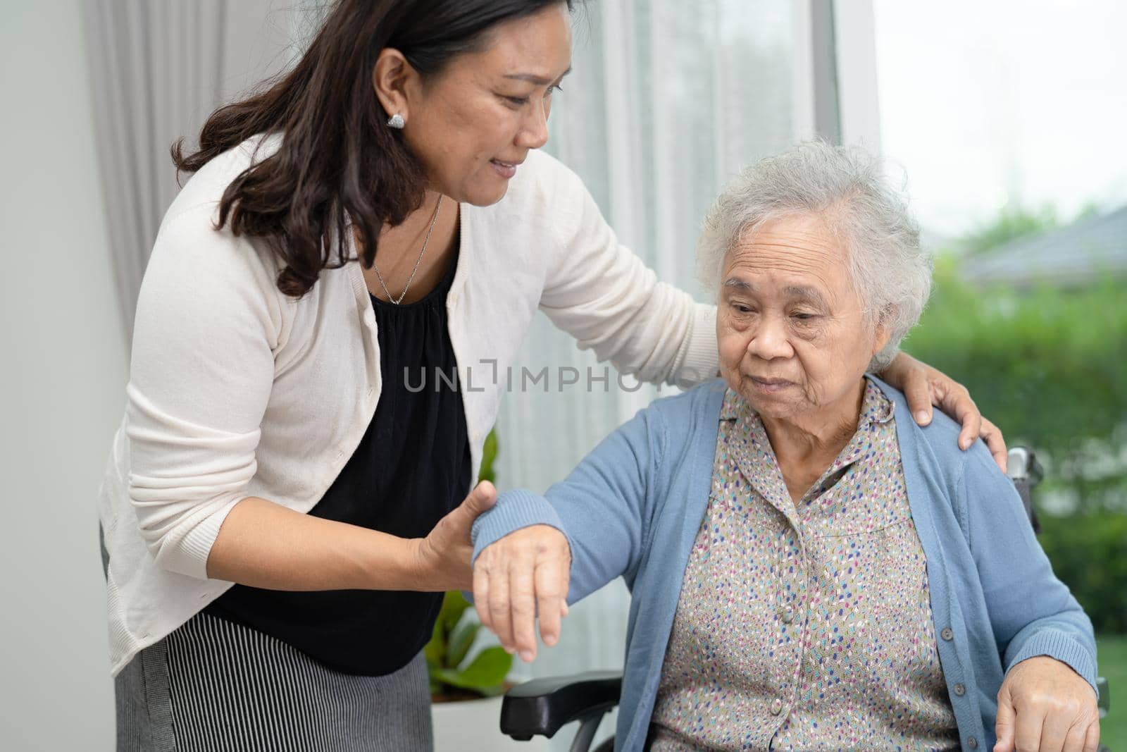 Help and care Asian senior or elderly old lady woman patient sitting on wheelchair at nursing hospital ward, healthy strong medical concept
