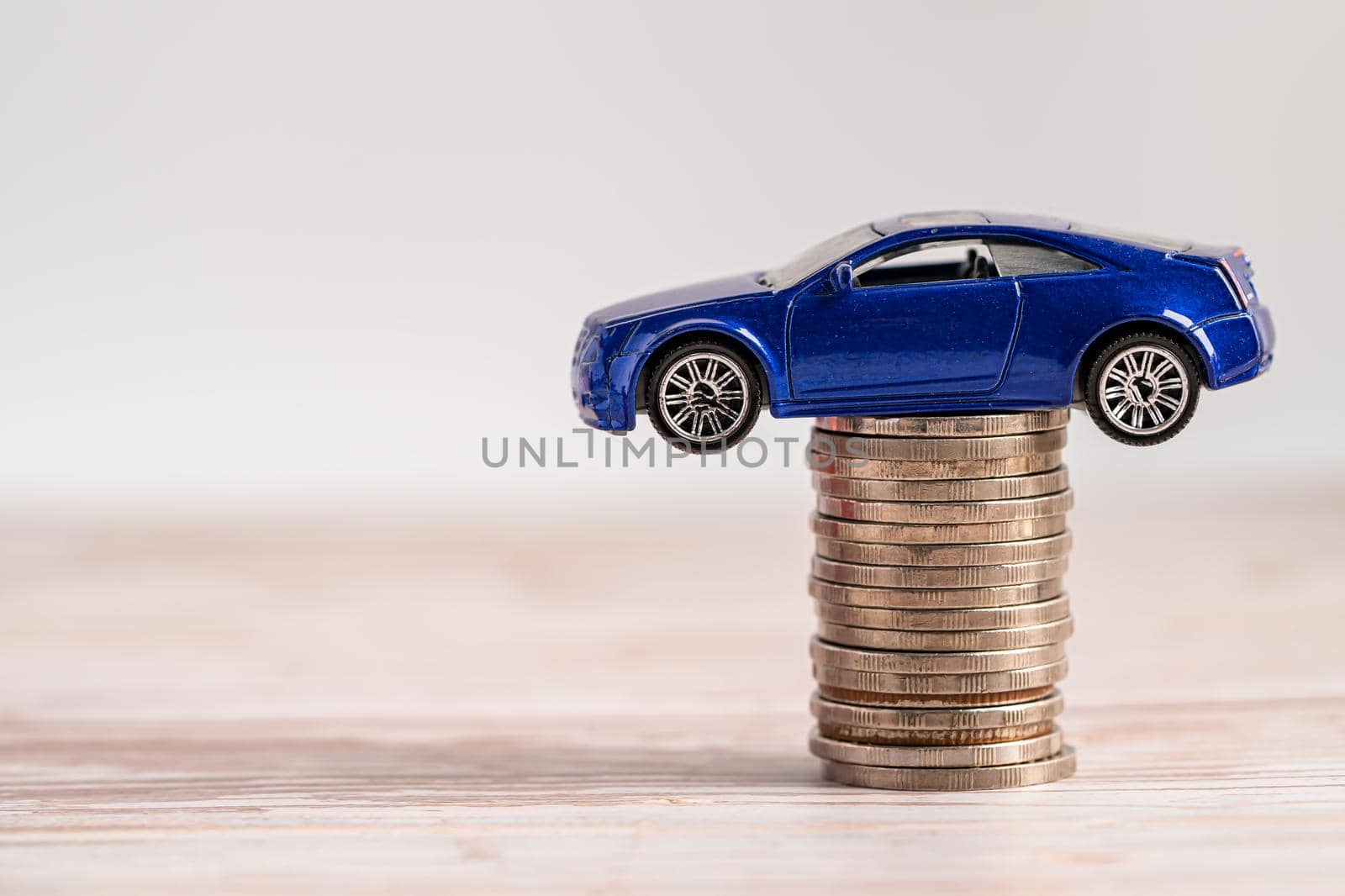 Car on stack of coins. Car loan, Finance, saving money, insurance and leasing time concepts. by pamai