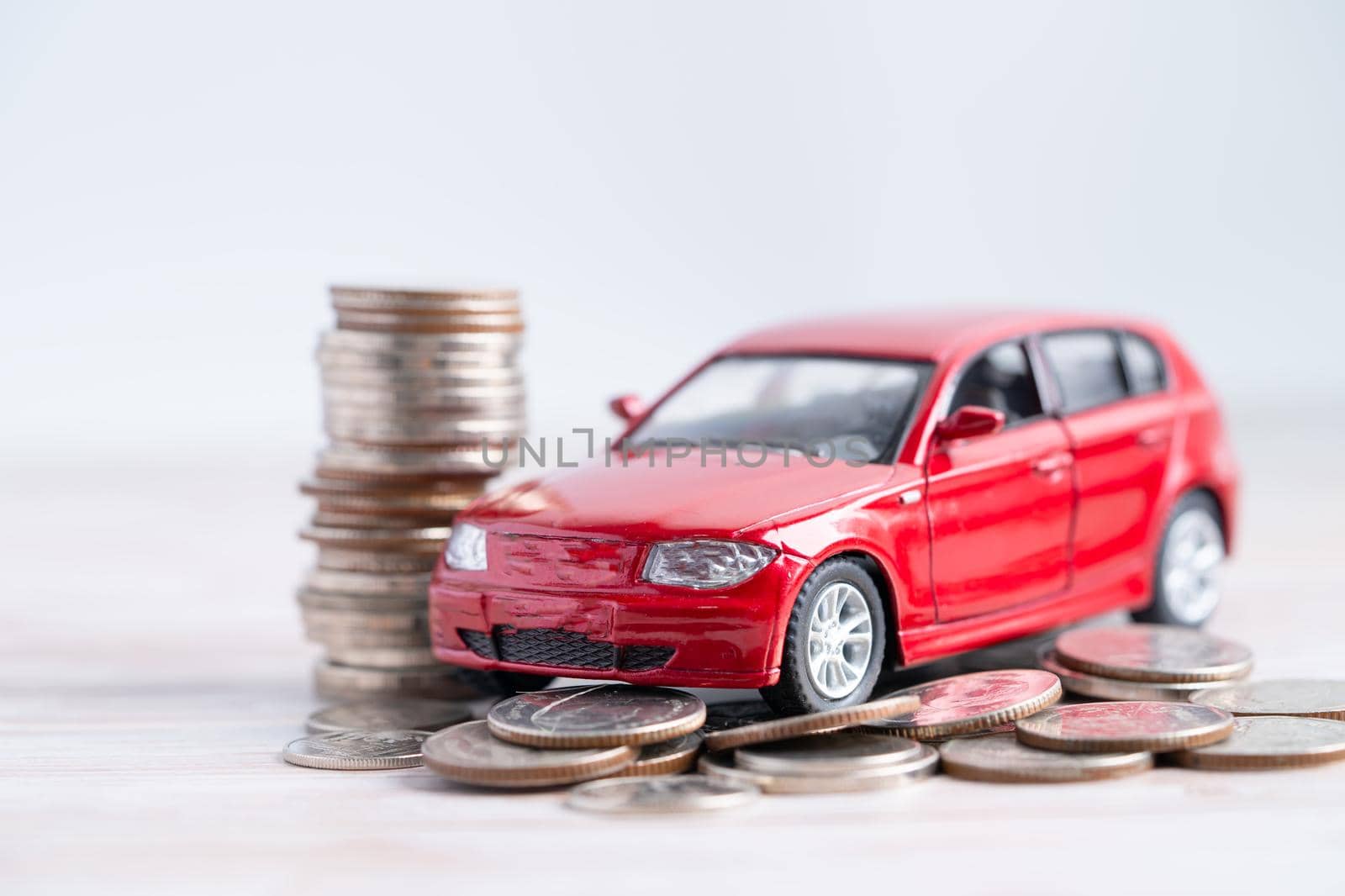 Car on stack of coins. Car loan, Finance, saving money, insurance and leasing time concepts. by pamai