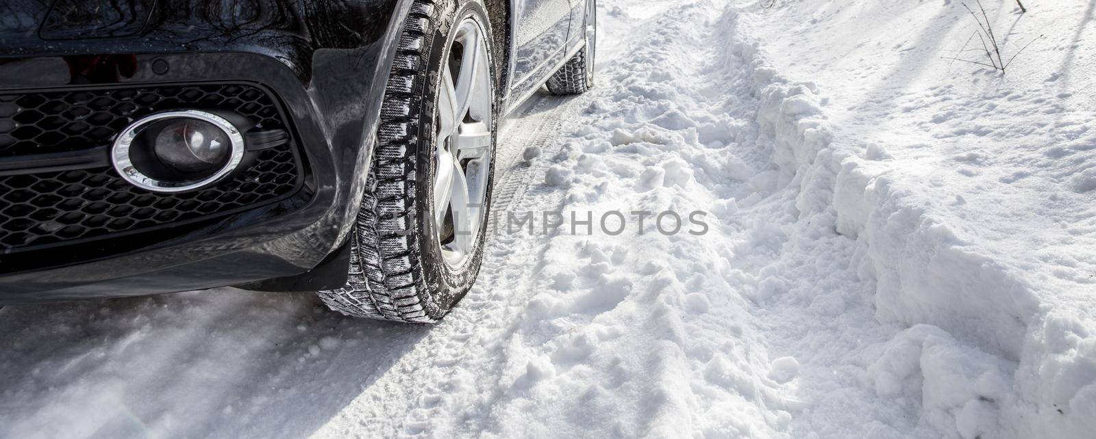 Driving SUV car in winter on forest road with much snow