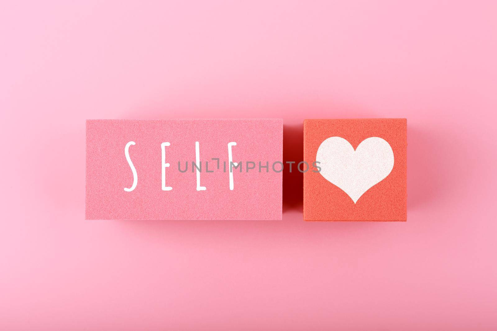 Trendy minimal self love creative concept in pink colors. Mental health, self acceptance, self care and respect or being single concept.