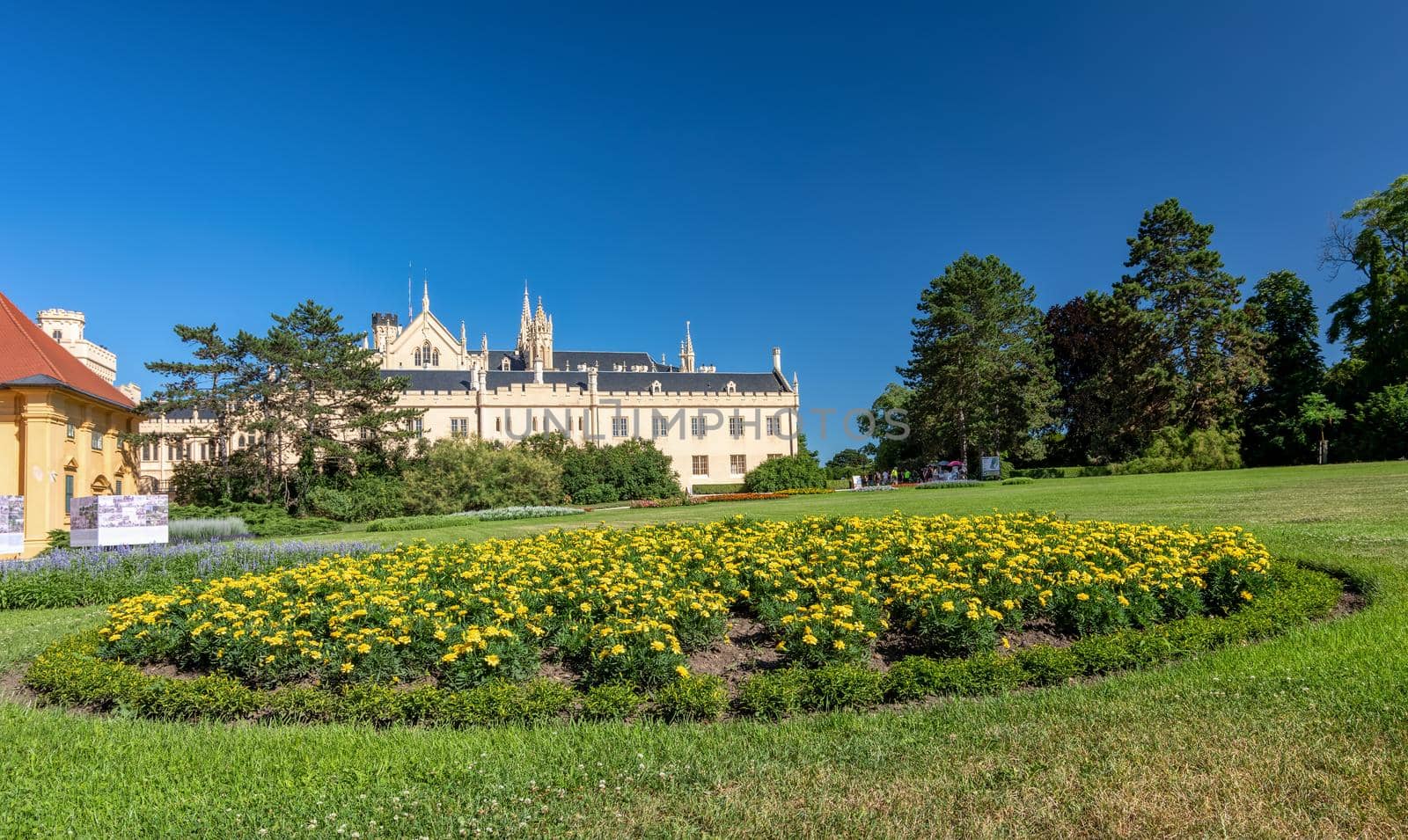 Lednice Chateau with beautiful gardens and parks on sunny summer day by artush