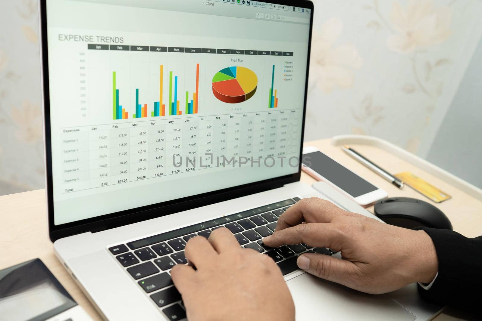 Asian accountant working and analyzing financial reports project accounting with chart graph and calculator in modern office, finance and business concept.