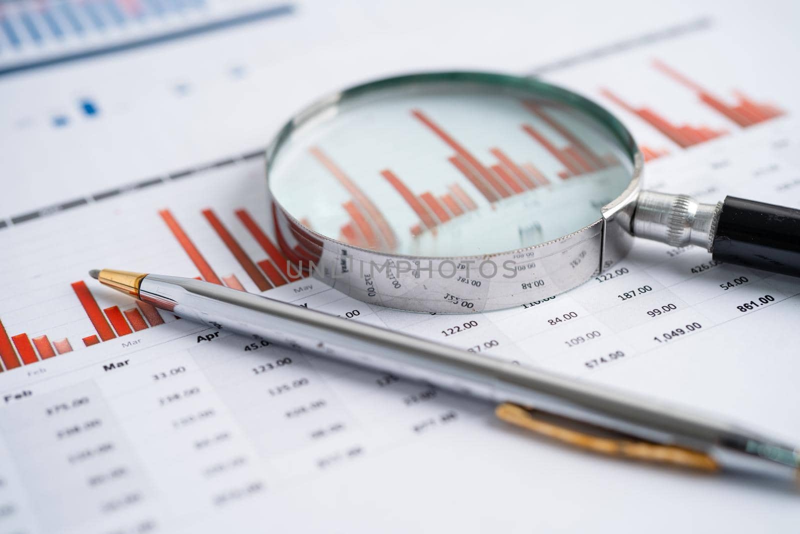 Magnifying glass on charts graphs paper. Financial development, Banking Account, Statistics, Investment Analytic research data economy, Stock exchange trading, Business office company meeting concept. by pamai