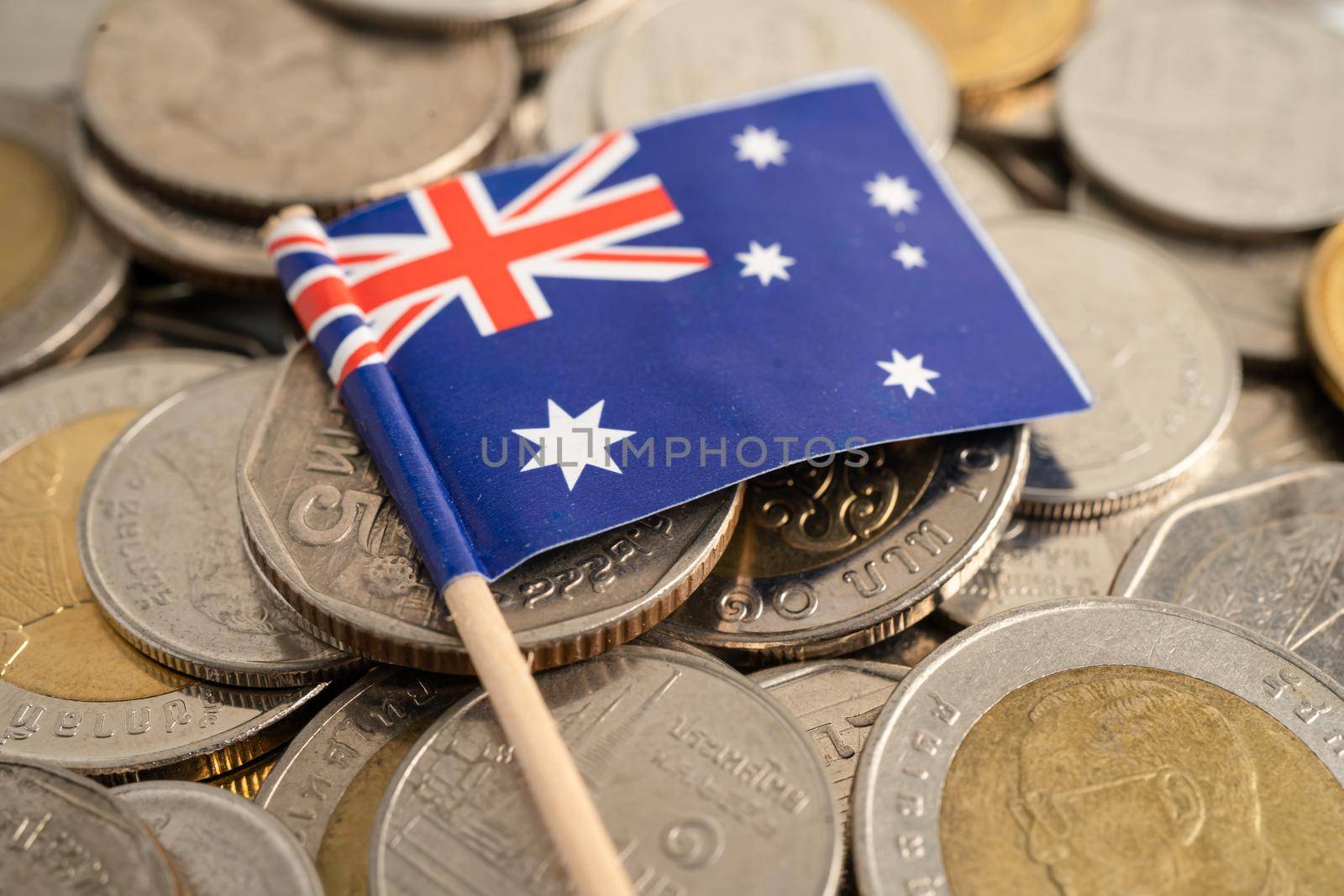 New Zealand flag on coins background, finance and accounting, banking concept.