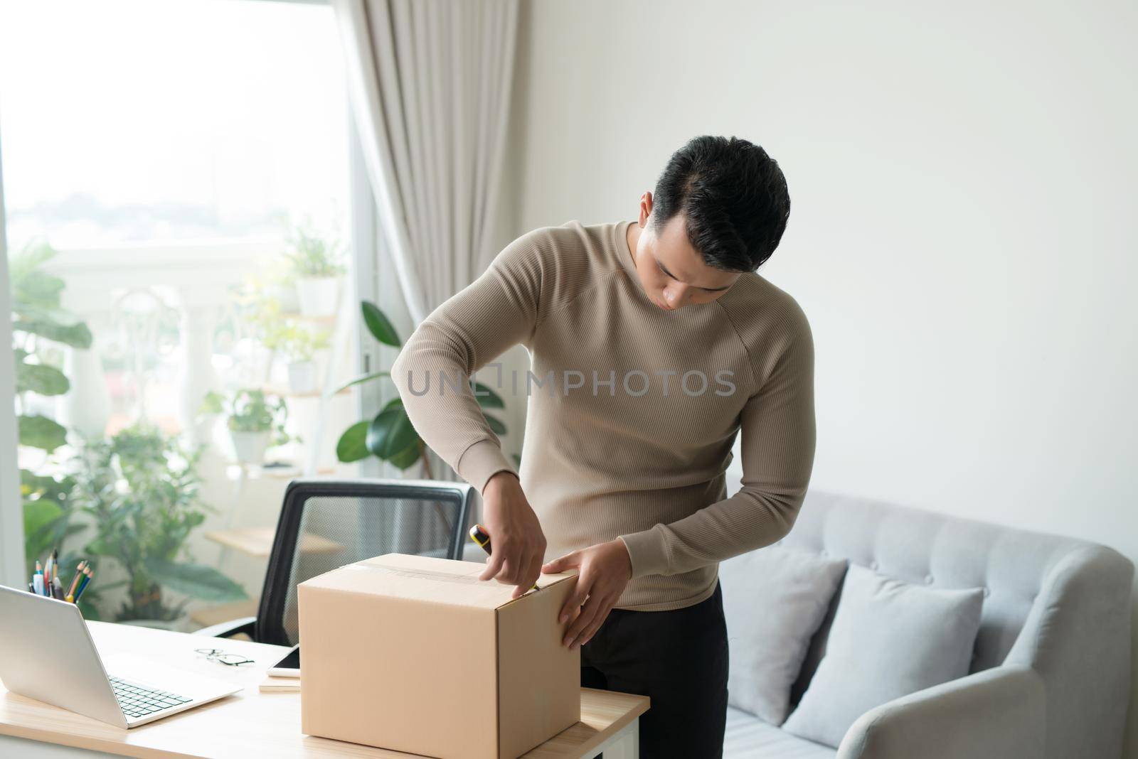 post, home and lifestyle concept - smiling man with cardboard boxes at home by makidotvn