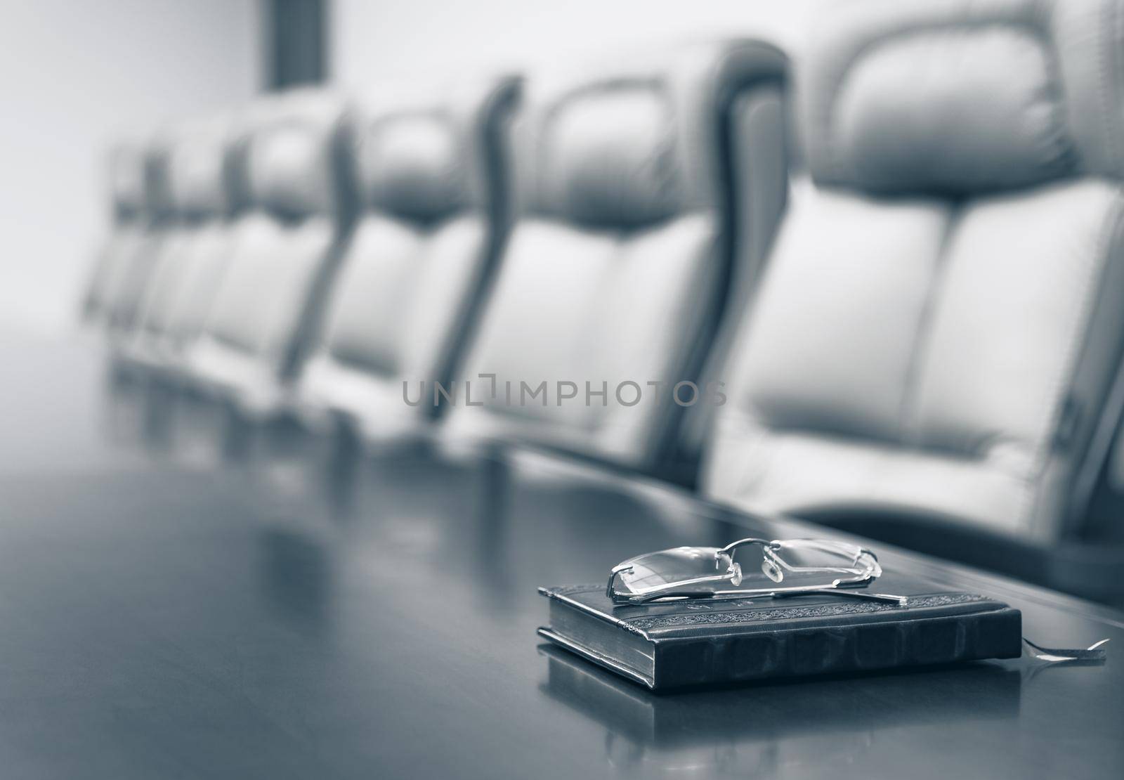 Closeup of on table in empty corporate conference room before business meeting in office