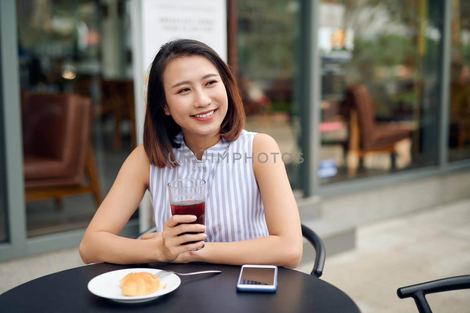 Beautiful woman drinking coffee in the morning sitting outdoors by makidotvn