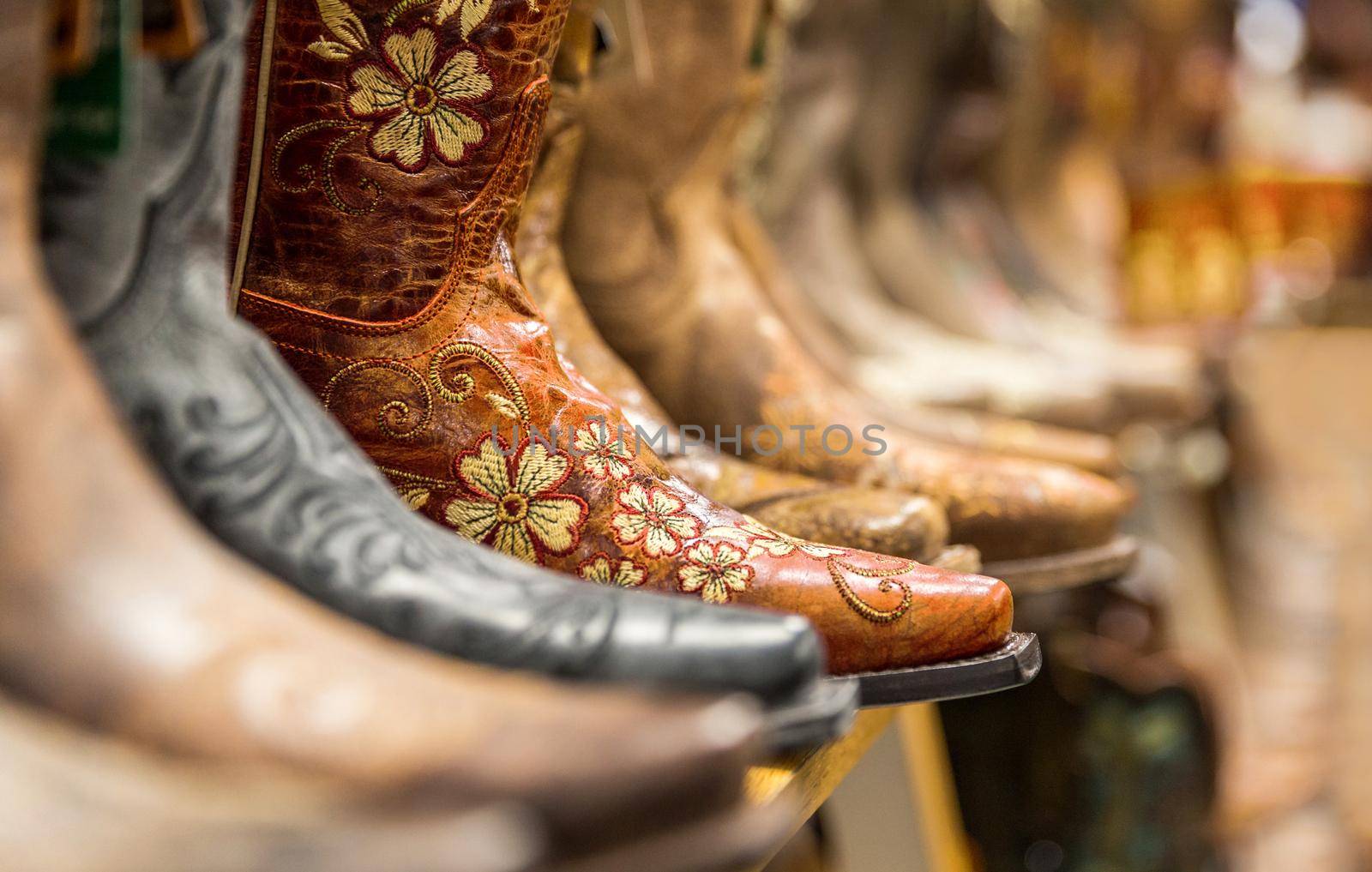 Close-up of new cowboy boots on shelf in a store