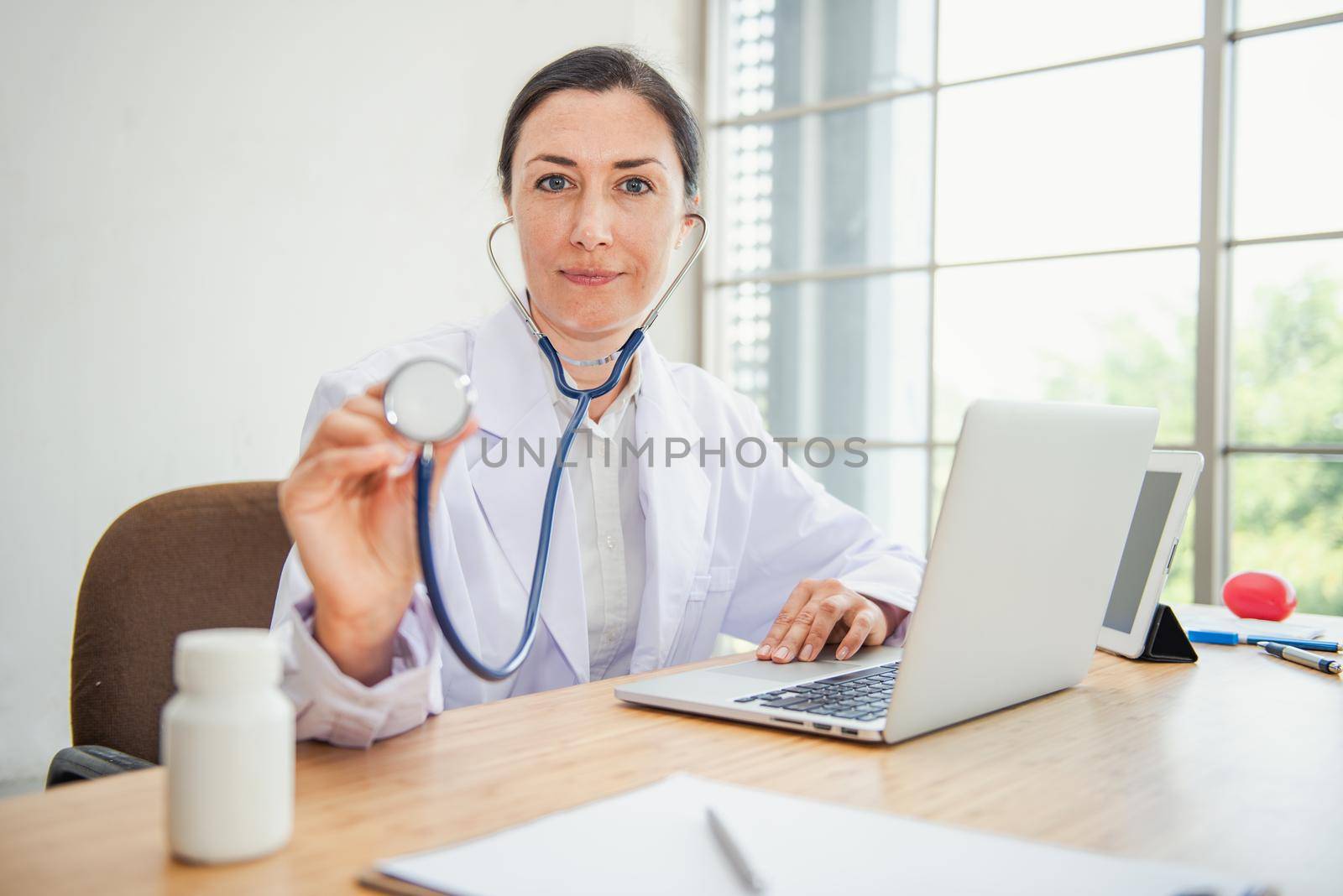 Medical Doctor is Examining Patient Health With Stethoscope in Hospital Examination Room, Female Physician Doctor is Diagnosing Physical Health Check Up for Patients. Medicine/Healthcare Concept by MahaHeang245789