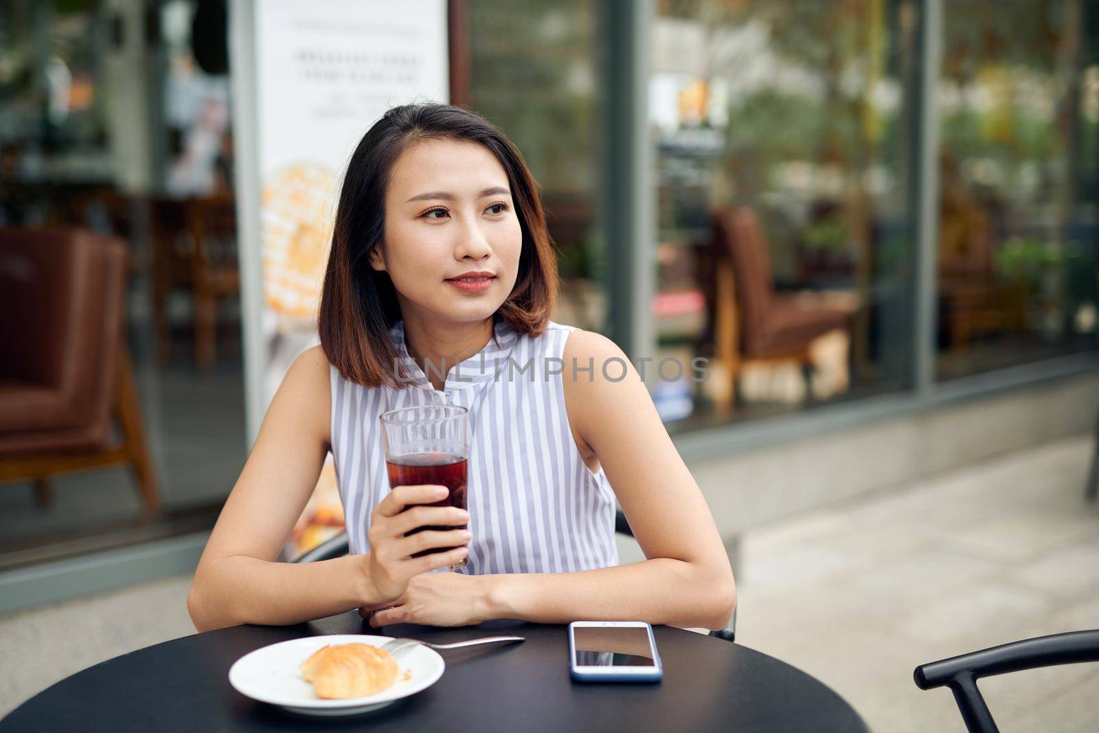 Woman enjoys fresh coffee in the morning at coffee shop 