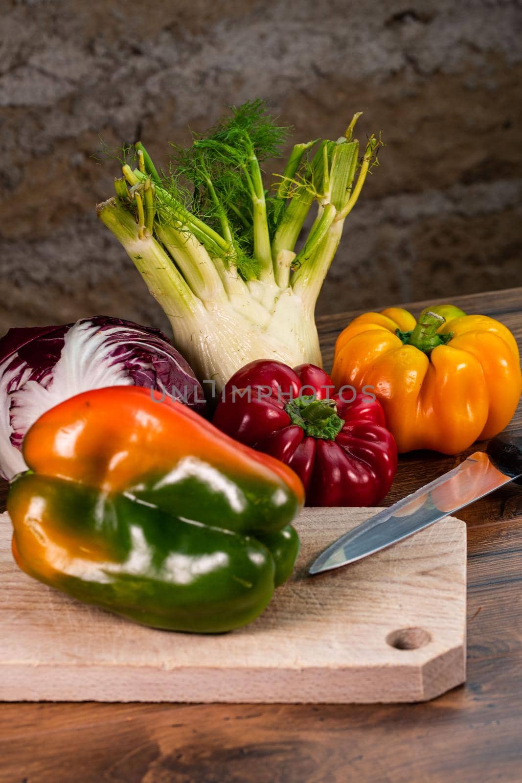 composition of vegetables with bark and cutting board on a wooden surface