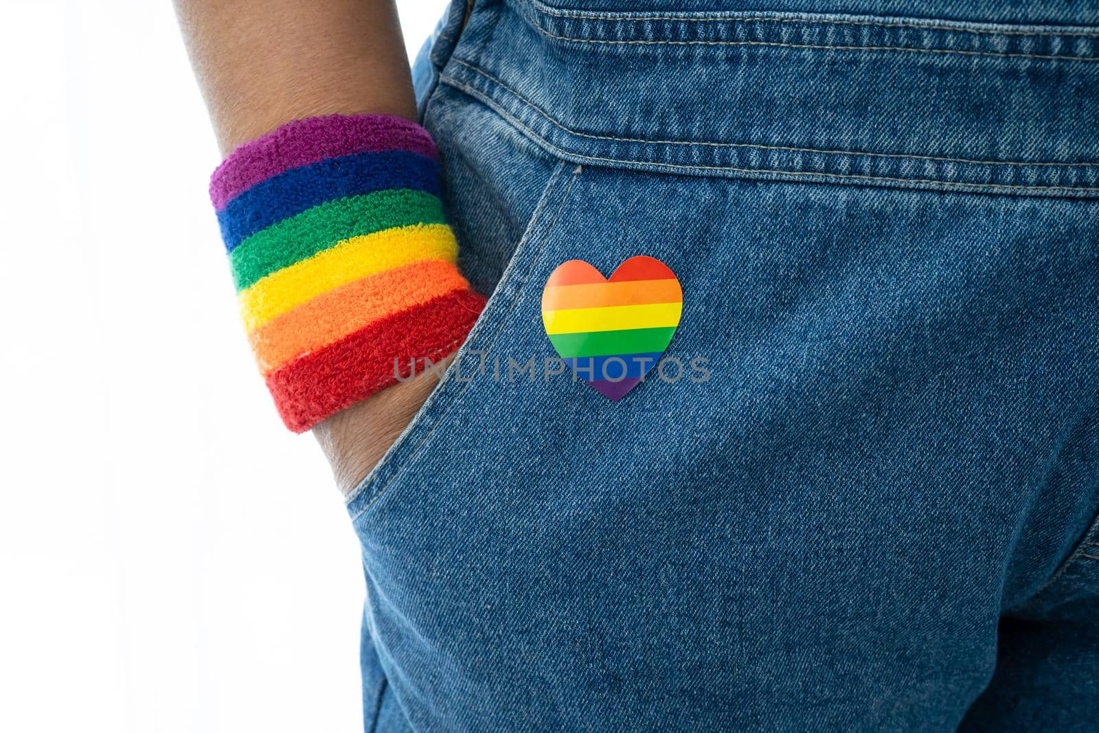 Asian lady wearing rainbow flag wristbands, symbol of LGBT pride month celebrate annual in June social of gay, lesbian, bisexual, transgender, human rights. by pamai