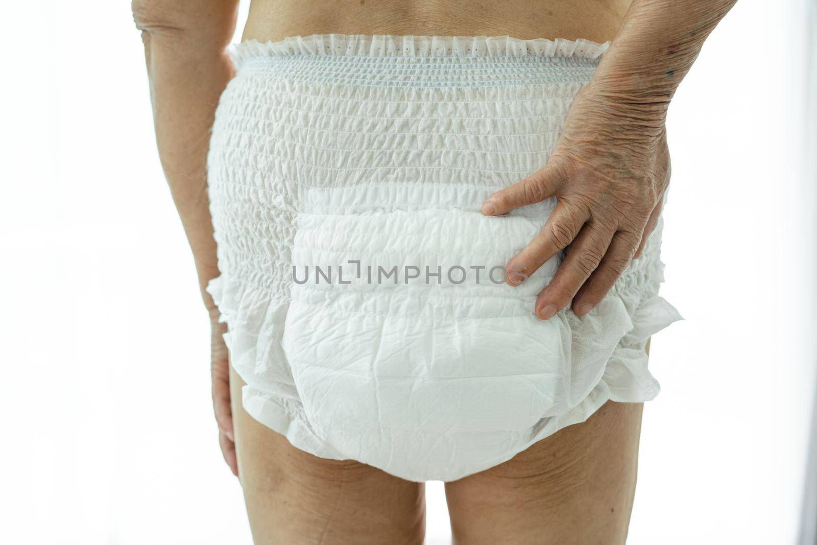 Asian senior or elderly old lady woman patient wearing incontinence diaper in nursing hospital ward, healthy strong medical concept.