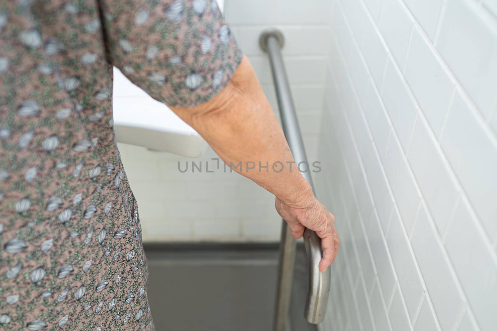 Asian senior or elderly old lady woman patient use toilet bathroom handle security in nursing hospital ward : healthy strong medical concept. by pamai