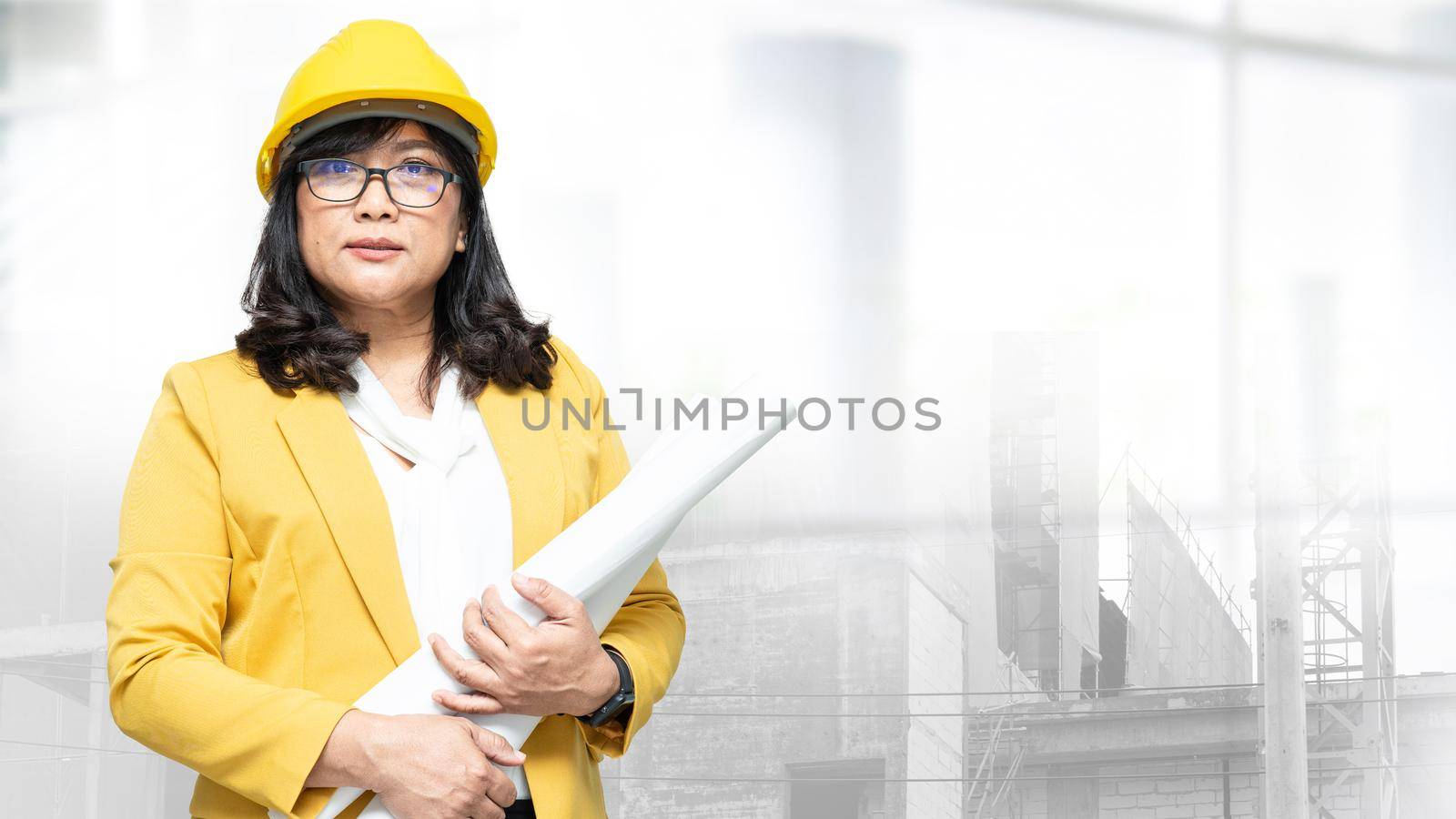 Architect or engineer working project accounting and construction helmet at building site, Construction account concept. by pamai