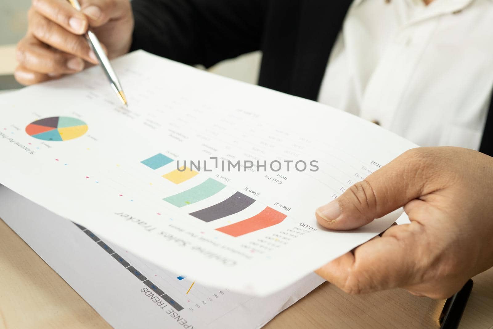 Asian accountant working and analyzing financial reports project accounting with chart graph and calculator in modern office, finance and business concept.