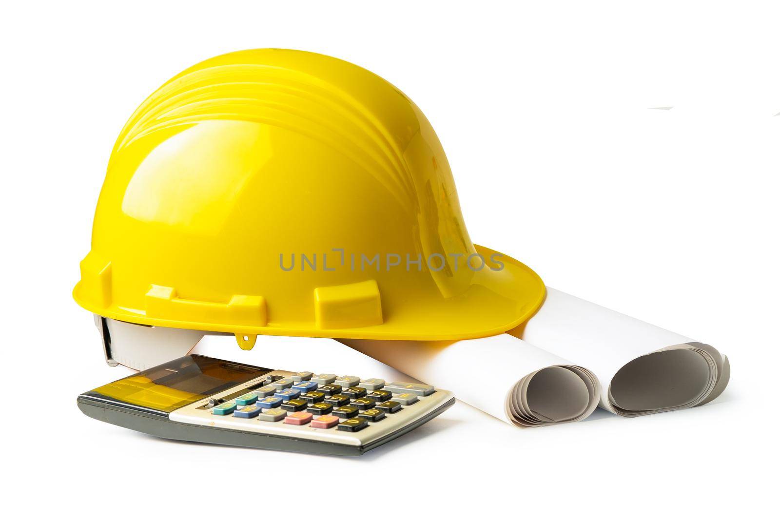 Yellow construction helmet and calculator isolated on white background with clipping path, engineer concept. by pamai
