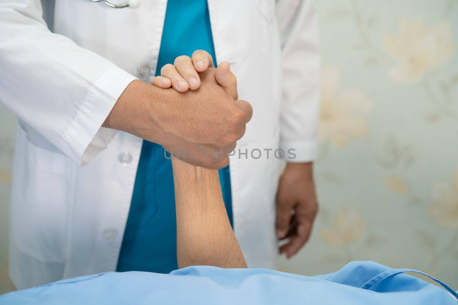 Holding hands Asian senior or elderly old lady woman patient with love, care, encourage and empathy at nursing hospital ward, healthy strong medical concept by pamai