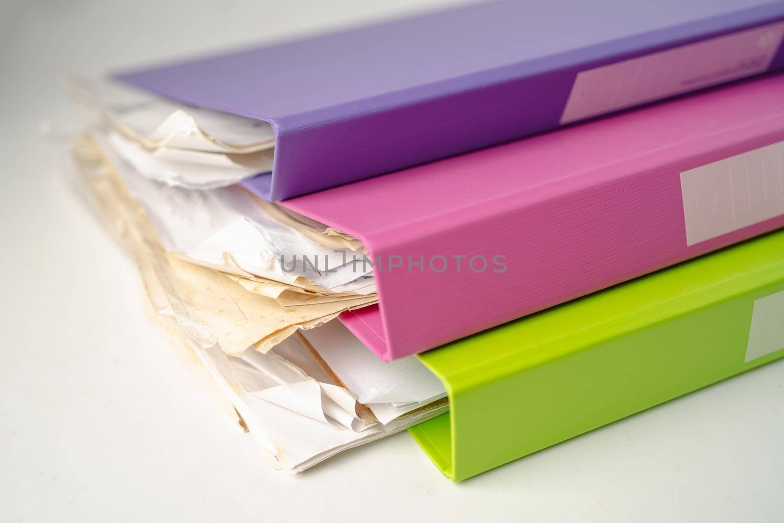 File Folder Binder stack of multi color on table in office. by pamai