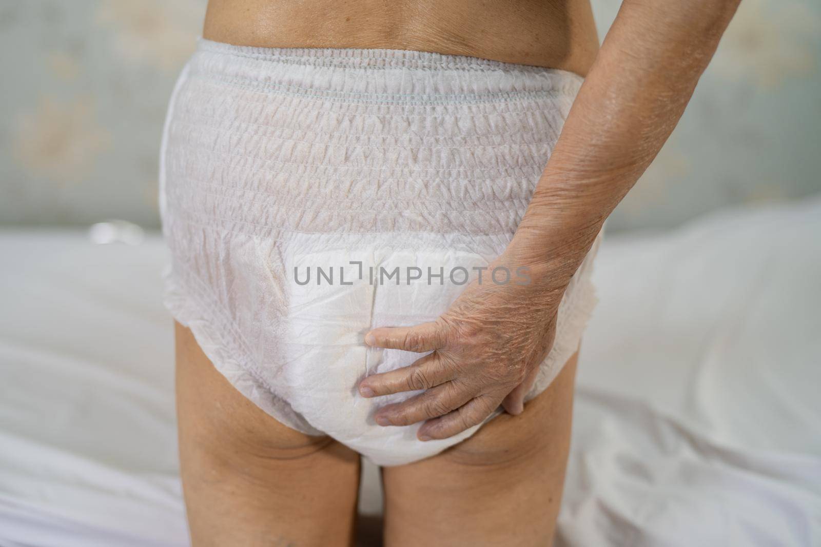 Asian senior or elderly old lady woman patient wearing incontinence diaper in nursing hospital ward, healthy strong medical concept.