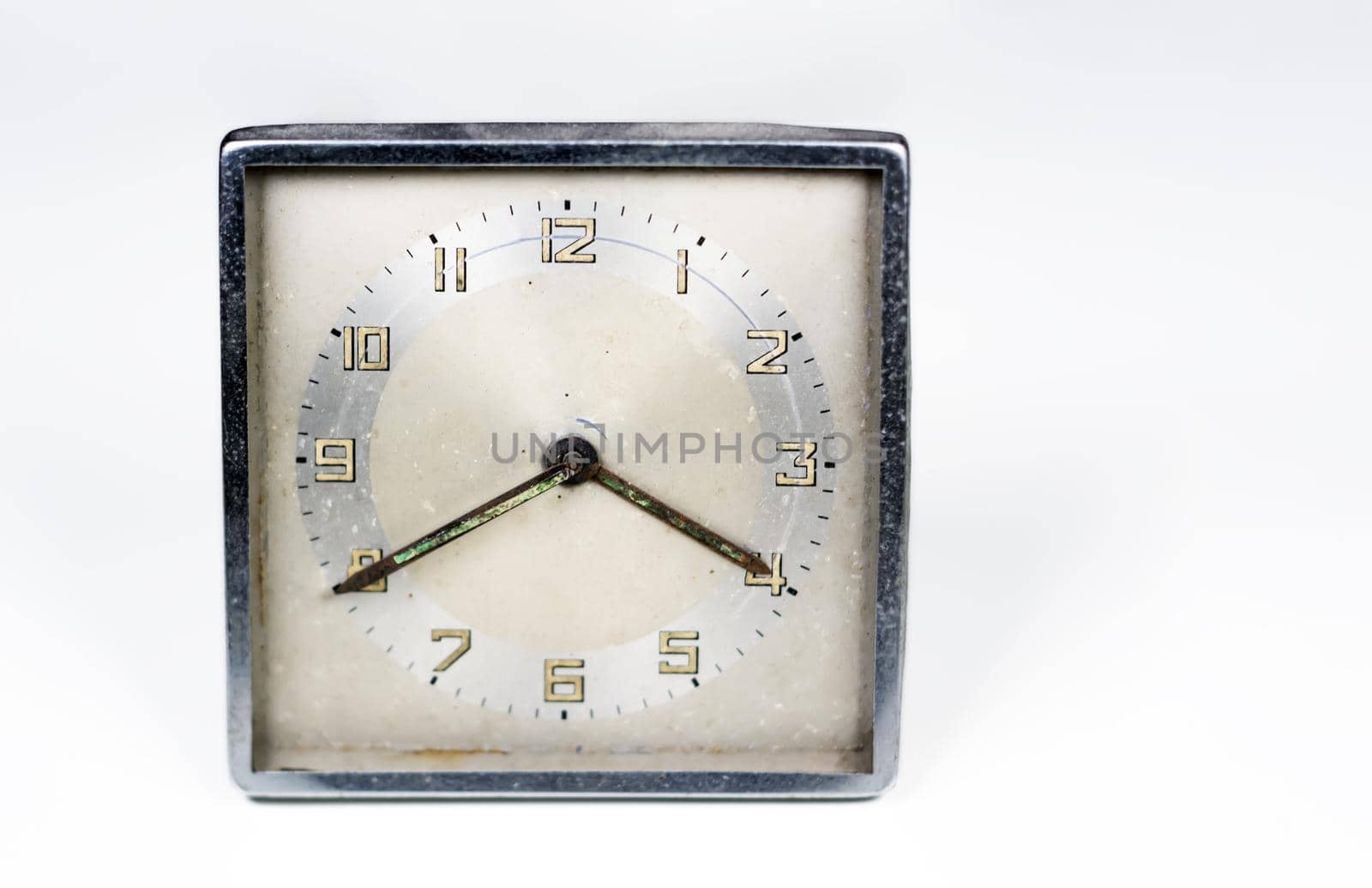 Old worn clock with square dial isolated on a white background. by rarrarorro