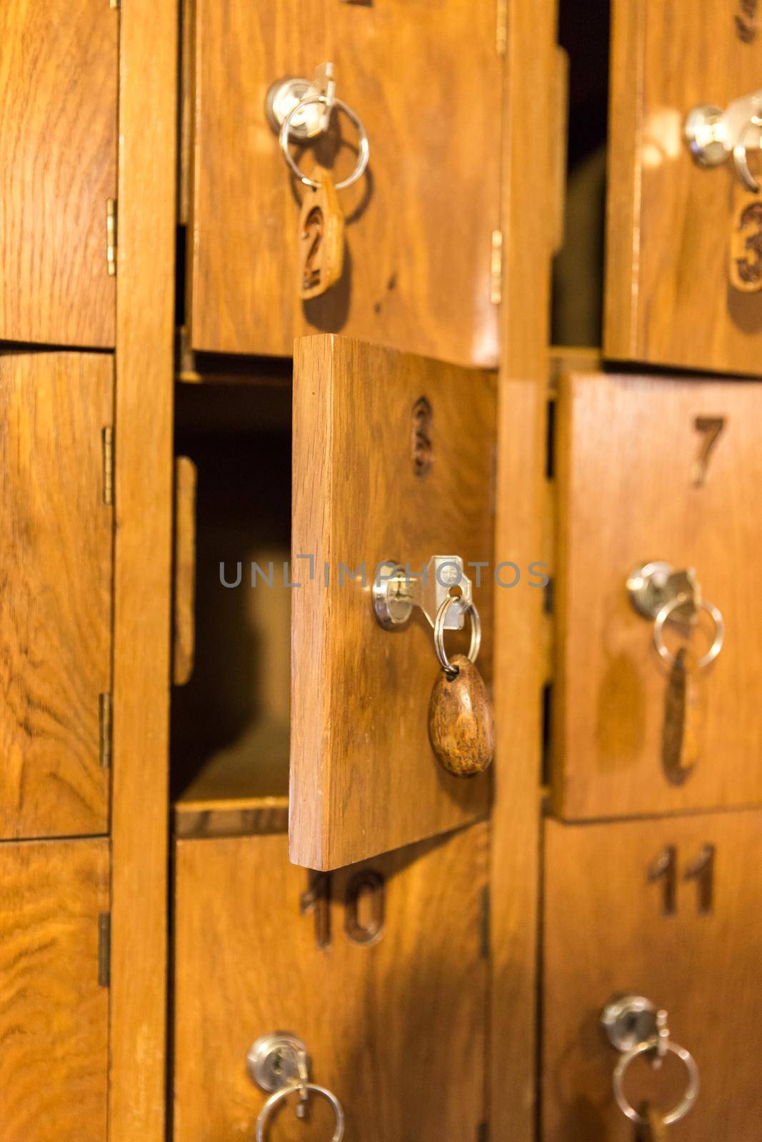 Wooden cells with keys for storing cell phones in Italian restaurant while eating