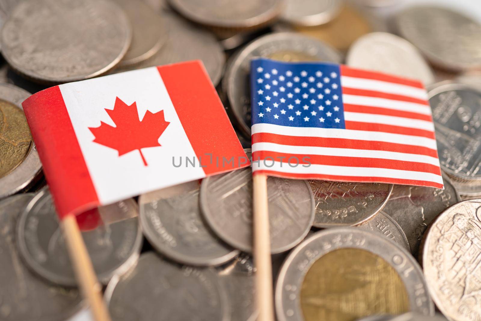 Stack of coins with USA America and Canada flag, finance concept. by pamai
