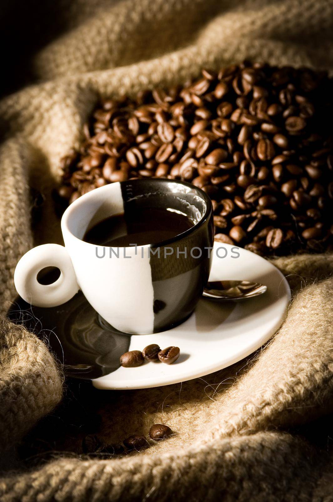 coffee cup and coffee beans on canvas