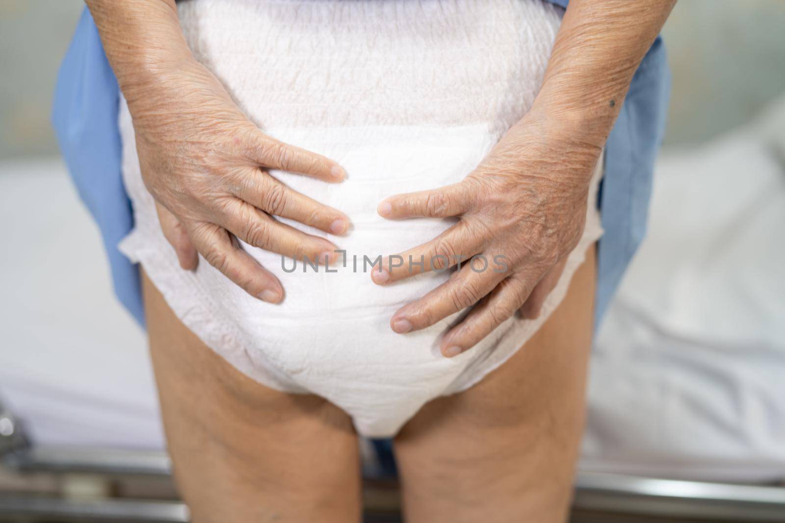 Asian senior or elderly old lady woman patient wearing incontinence diaper in nursing hospital ward, healthy strong medical concept.