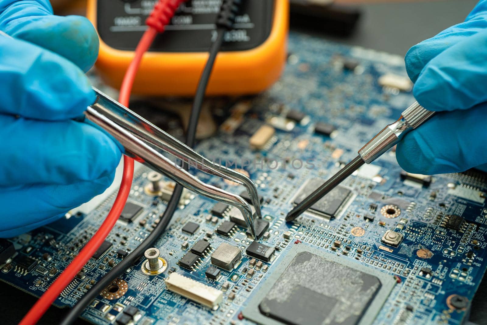 technician repairing inside of hard disk by soldering iron. Integrated Circuit. the concept of data, hardware, technician and technology.