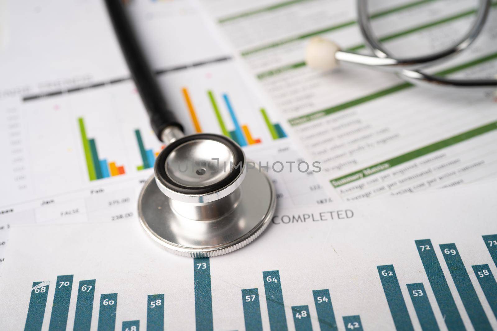 Stethoscope on charts and graphs paper, Finance, Account, Statistics, Investment, Analytic research data economy and Business company concept.