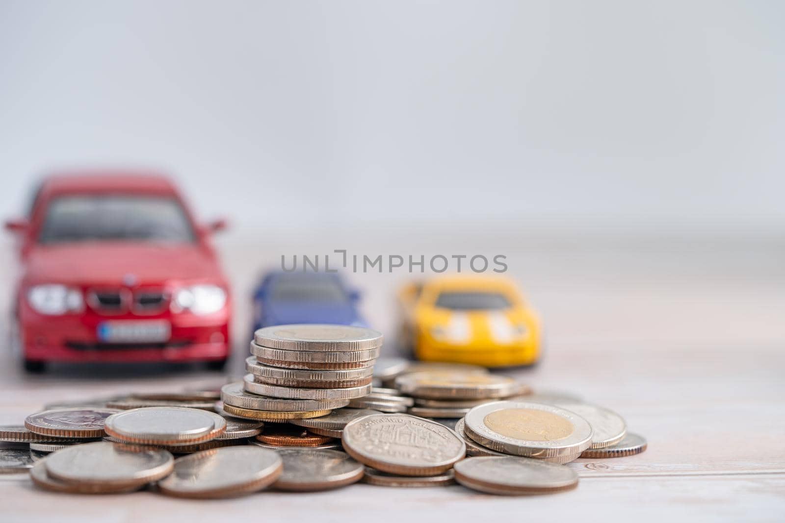 Car on coins background; Car loan, Finance, saving money, insurance and leasing time concepts. by pamai